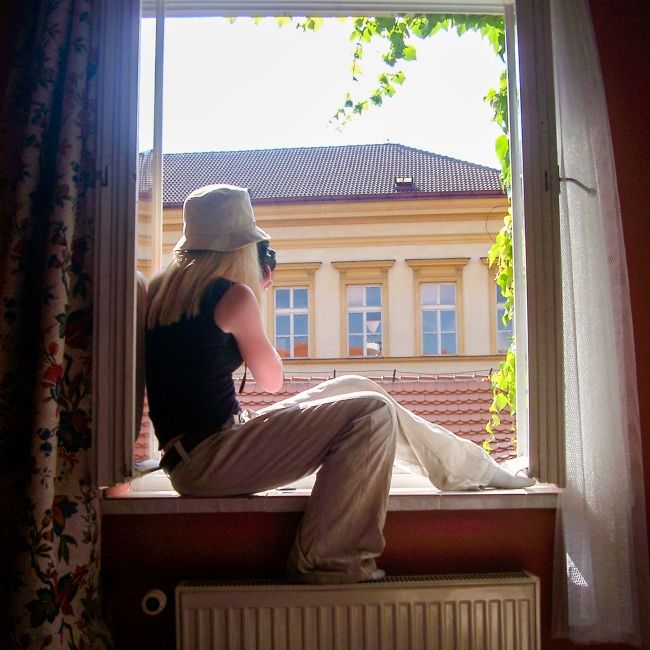 prague girl in window with camera