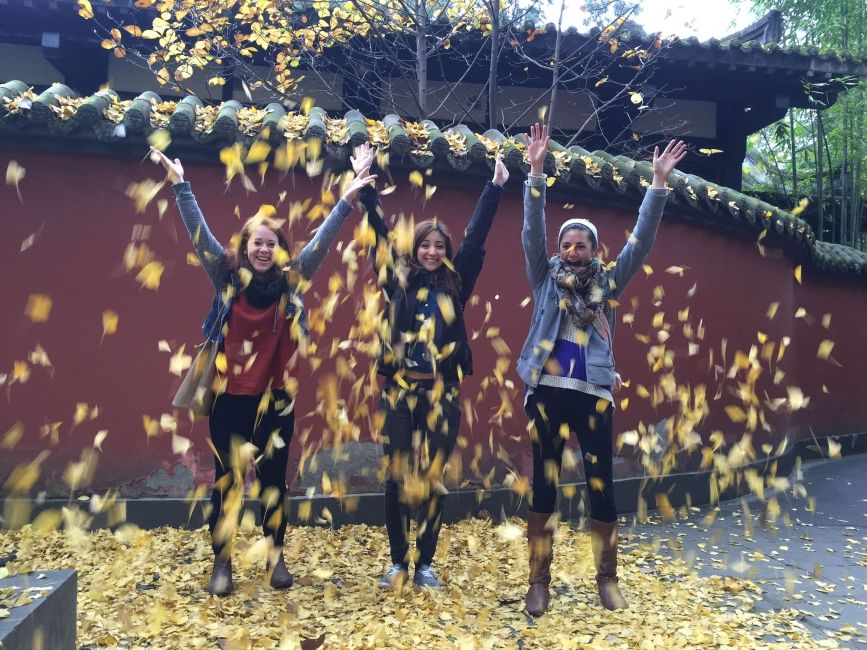 Teachers throwing leaves in the air in China