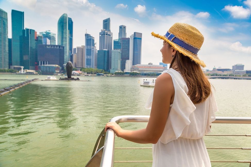 singapore girl on boat looking at buildings