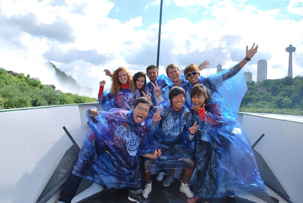 singapore students wearing ponchos on a boat