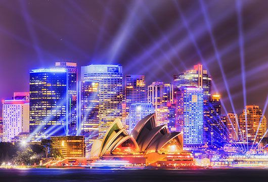 sydney opera house at night with spotlights