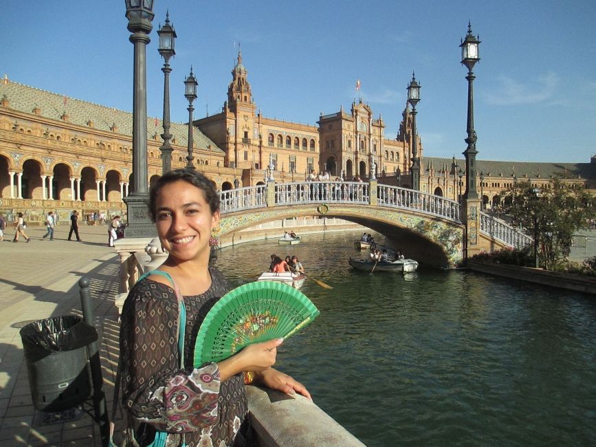 Barcelona_Female participant standing with fan next to railing and canal.jpg