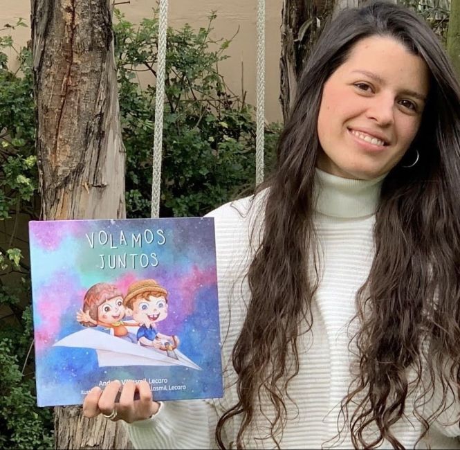 Andrea holding her book "Flying Together" 