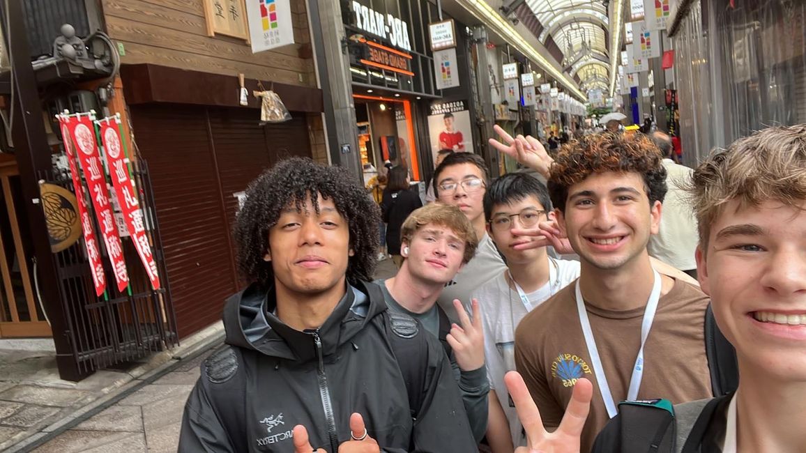 Teenage boys posing in shopping center in Asia