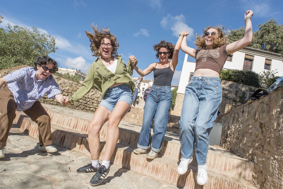 Gap year students jumping off steps on program excursion