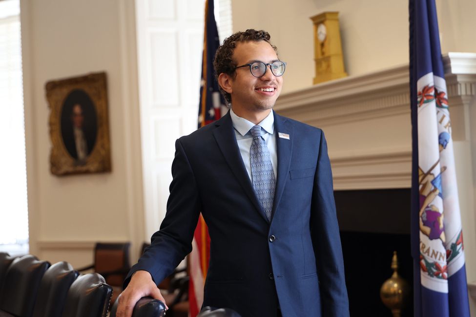 gregory perryman standing in a suit in a university office building
