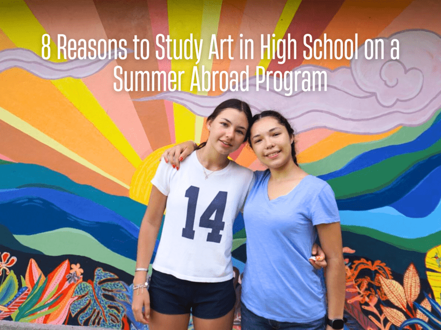 High school students standing in front of colorful mural