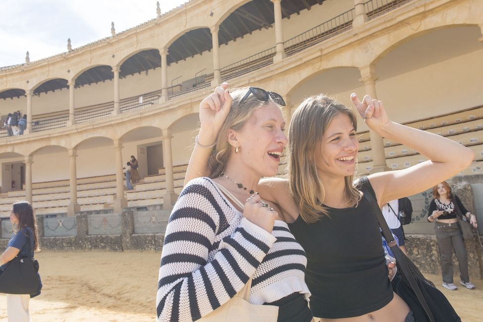 Students posing in old building abroad