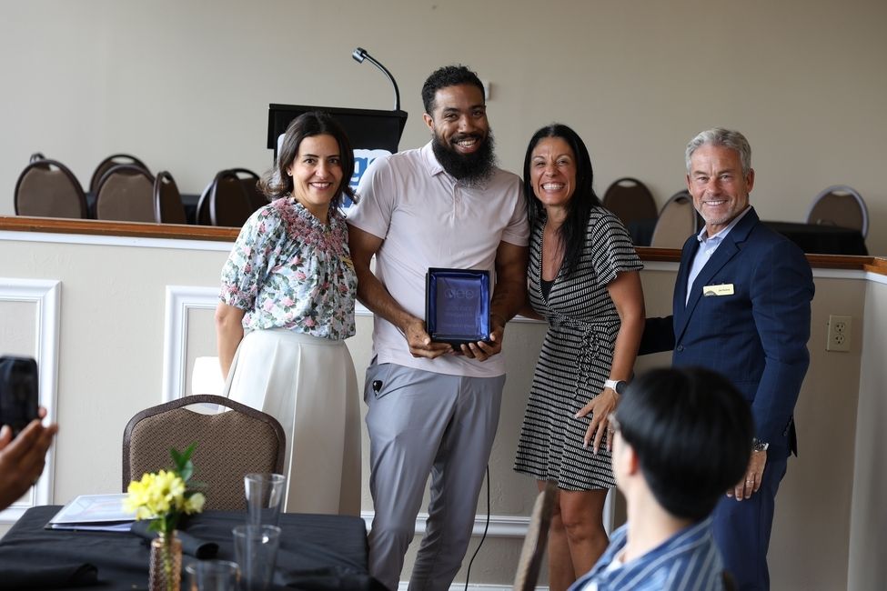 a group of people accepting an award