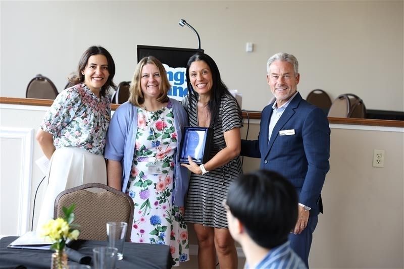 a group of people accepting an award