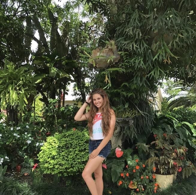 Octavia Tey poses in a lush tropical garden during her CIEE study abroad program in the Dominican Republic.