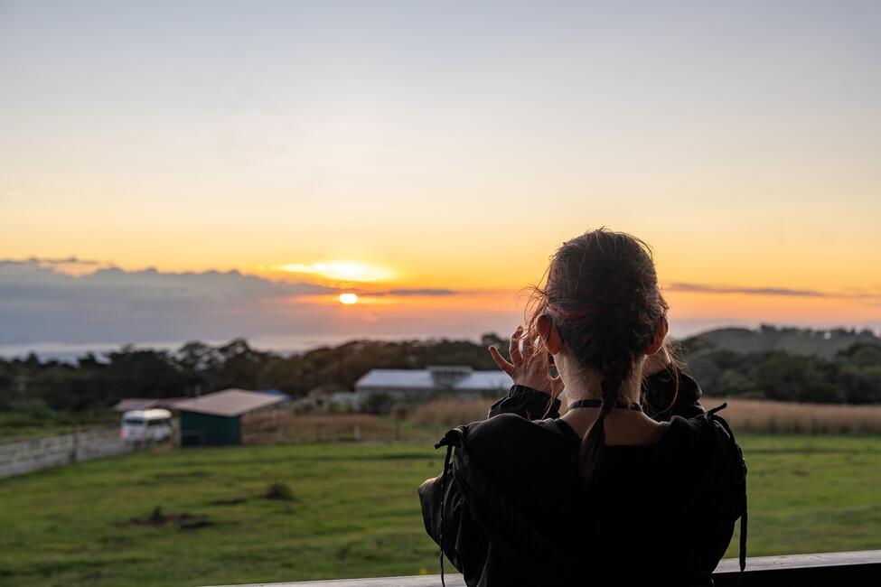 Student taking photo of beautiful sunset in Monteverde