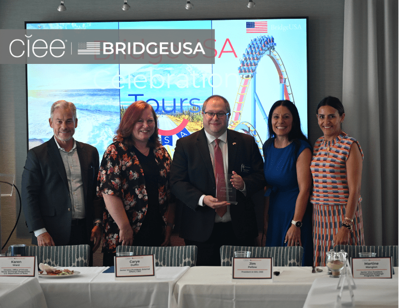 CIEE and BridgeUSA representatives pose with an award recipient during a BridgeUSA Celebration Tour event