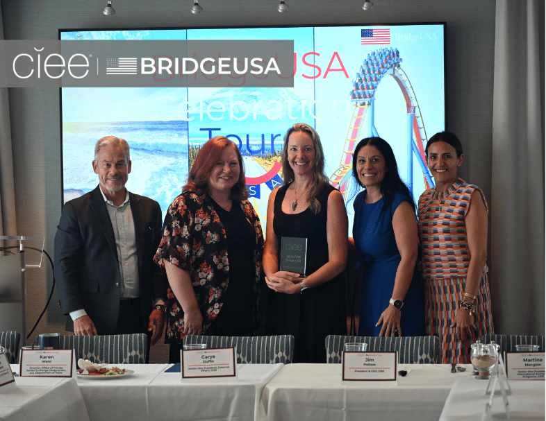 CIEE and BridgeUSA representatives pose with an award recipient during a BridgeUSA Celebration Tour event
