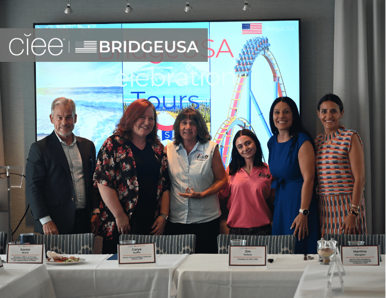 CIEE and BridgeUSA representatives pose with an award recipient during a BridgeUSA Celebration Tour event