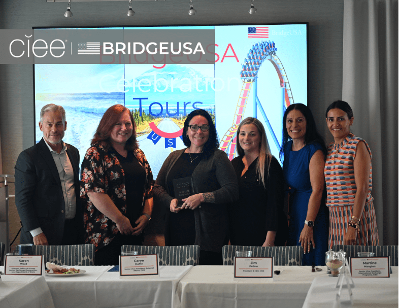 CIEE and BridgeUSA representatives pose with an award recipient during a BridgeUSA Celebration Tour event
