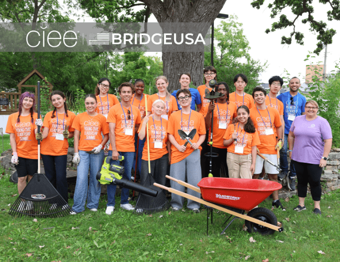 CIEE BridgeUSA Young Civic Leadership Summit participants pose with landscaping tools after a community cleanup in Wisconsin Dells