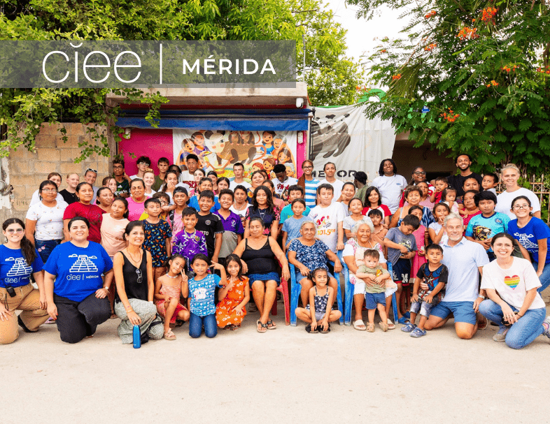 A group of students and volunteers and CIEE staff stand together and smile in Merida, Mexico