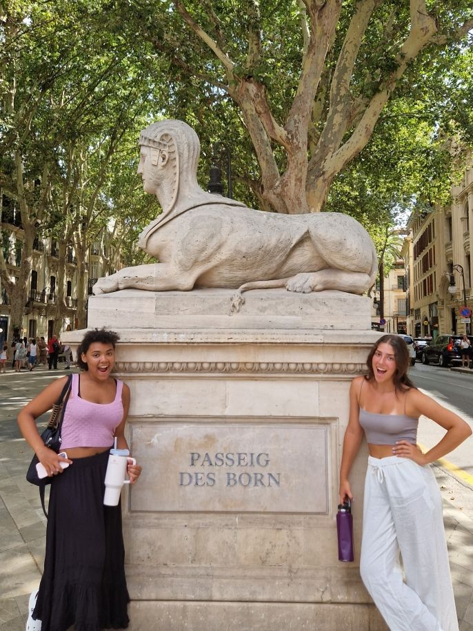 Aaliyah & Janna with one of the two sphynxes that sits watch at the beginning of Passeig des Born, a famous area of the city filled with shops and restaurants