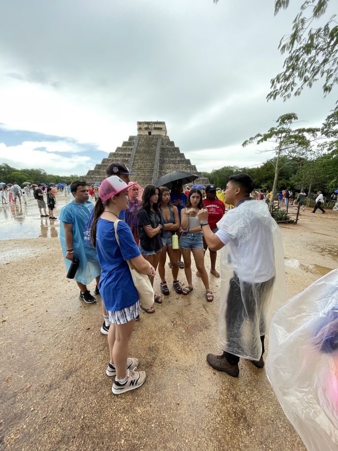 Enjoying our fascinating tour guide at Chichen Itza