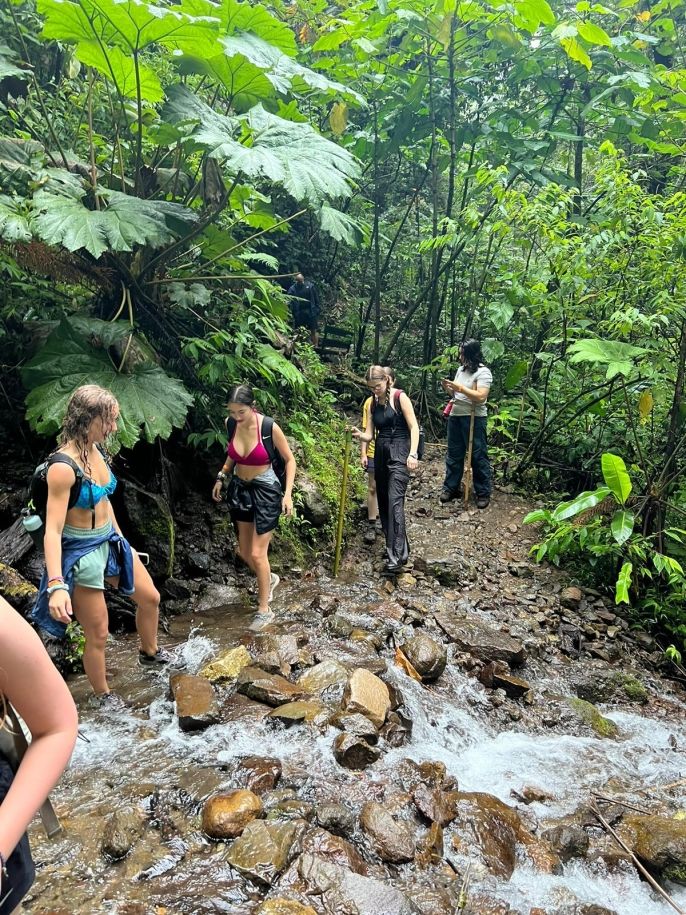 Tory, Baila, Brave and Sarah crossing a stream during our hike at El Tigre Waterfalls.