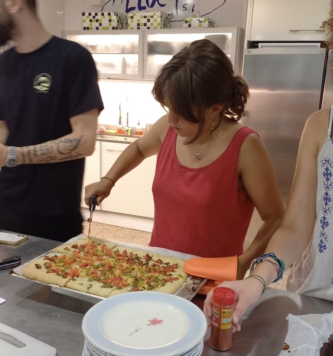 Ella cutting up the "coca", a traditional Mallorcan dish, after it cools from its time in the oven