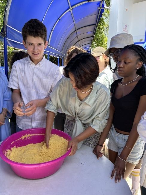 Students fluffing the couscous