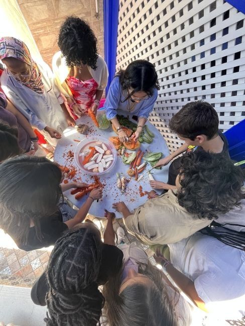 Students cutting up vegetables for the couscous