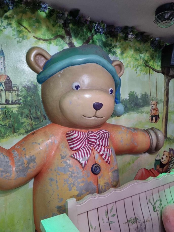 A creepy bear figurine in a noraebang (karaoke room).