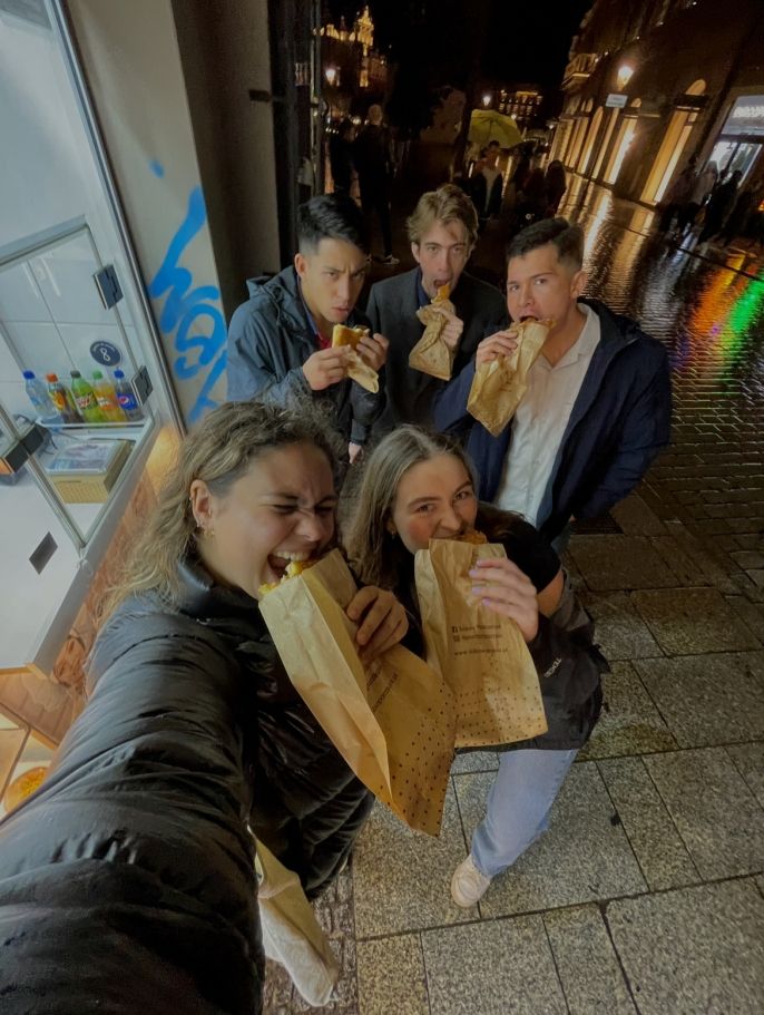 students abroad eating pastries together
