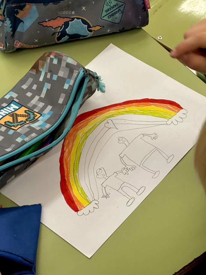 Kid drawing a cute rainbow