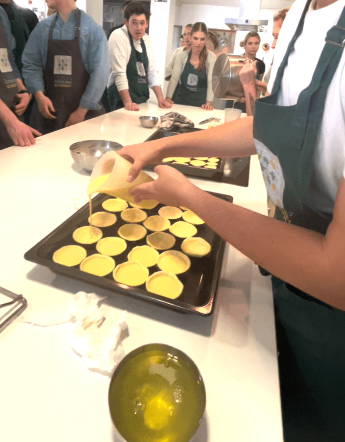 Pouring the custard into the pastries!