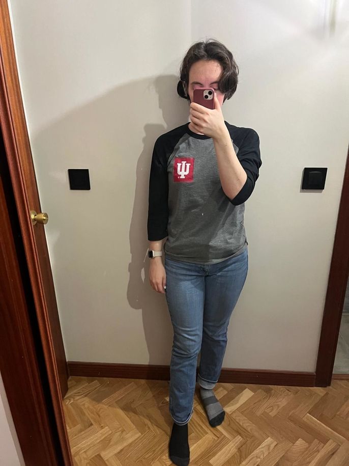 A 3/4 sleeve baseball-style shirt and jeans