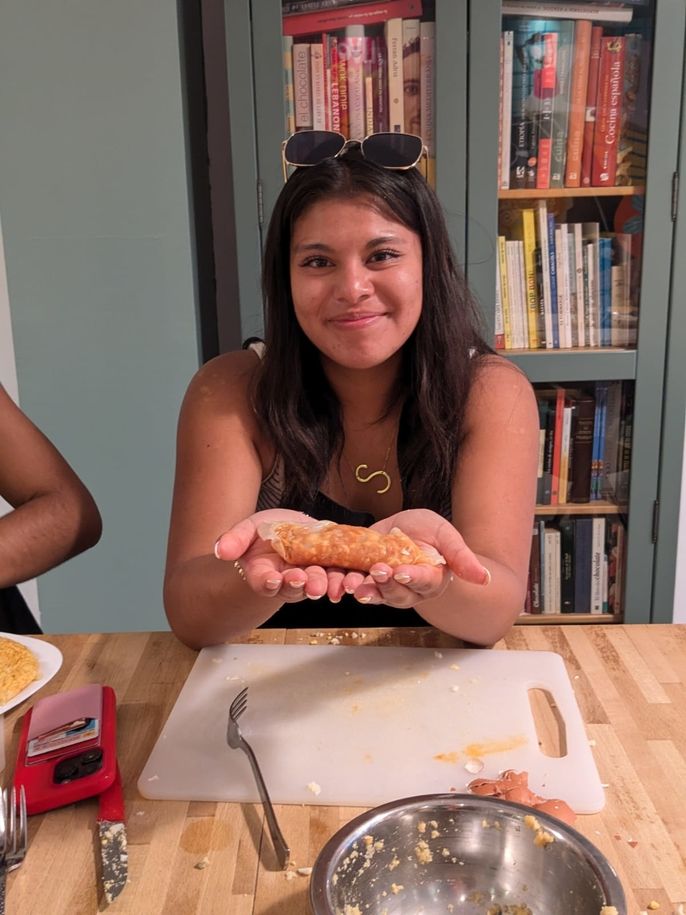 A student holding up her tapa. 