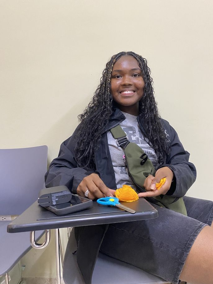 A student makes a flower.