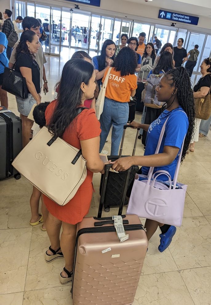 Students greet their homestay families at the airport