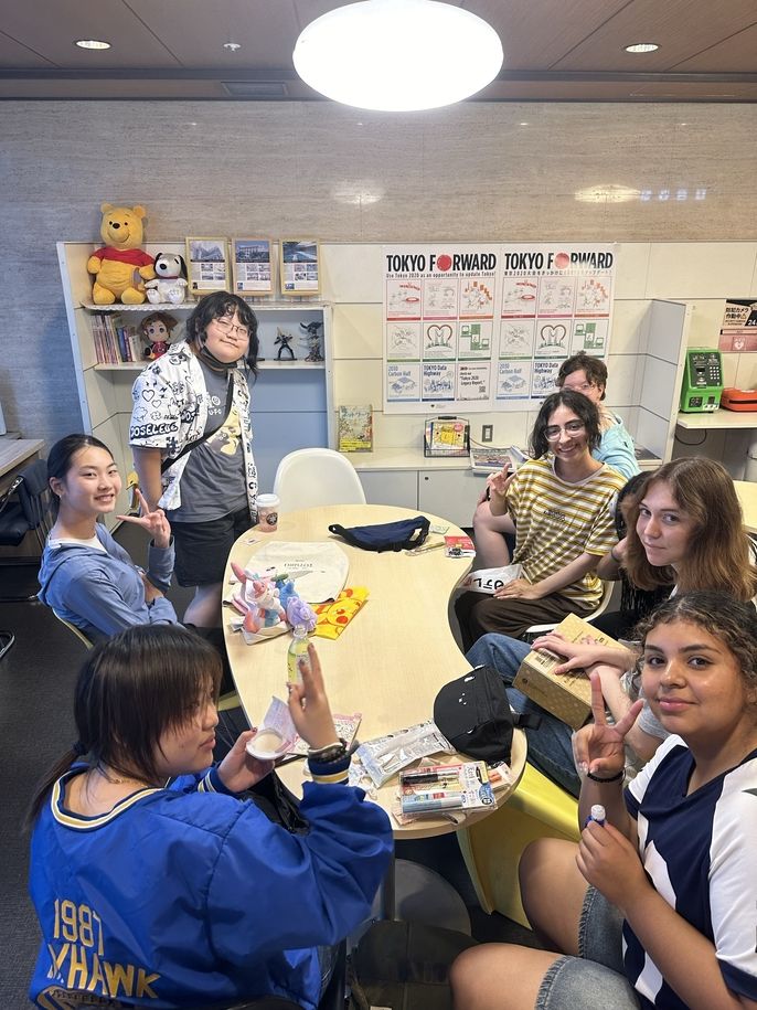 Global Navigators show off their finds in the hostel lobby together.