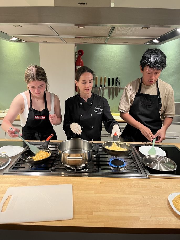 2 students cooking a Spanish omelette. 