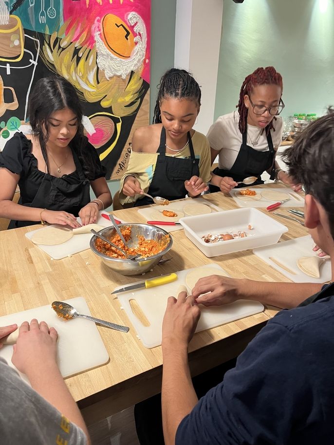 A few students dressing their tapas dishes. 