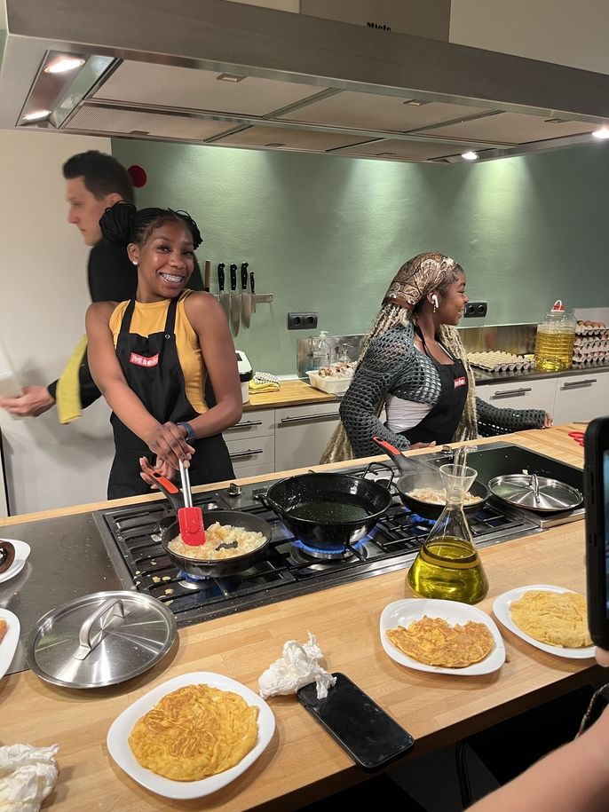 A student smiling while cooking