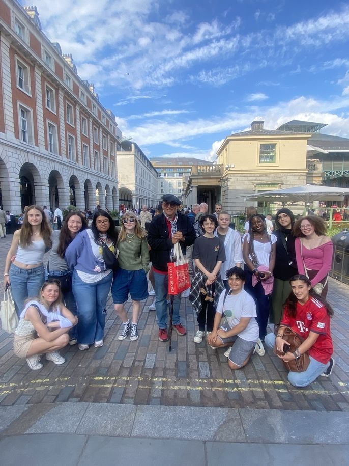 Students posing with Dicken's Walking Tour guide