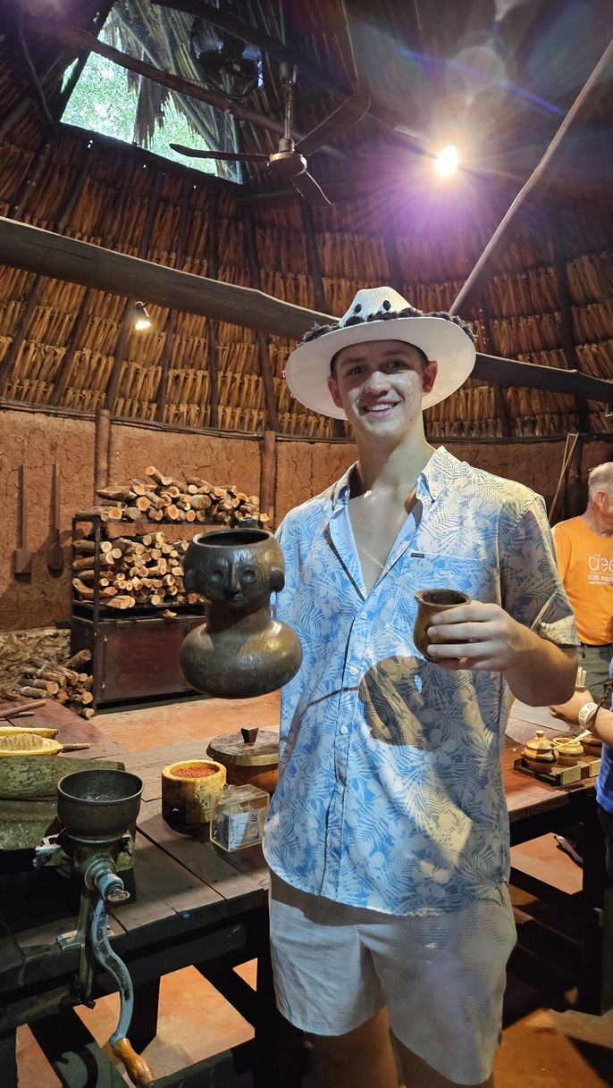 Student shows a vessel used to prepare a chocolate drink