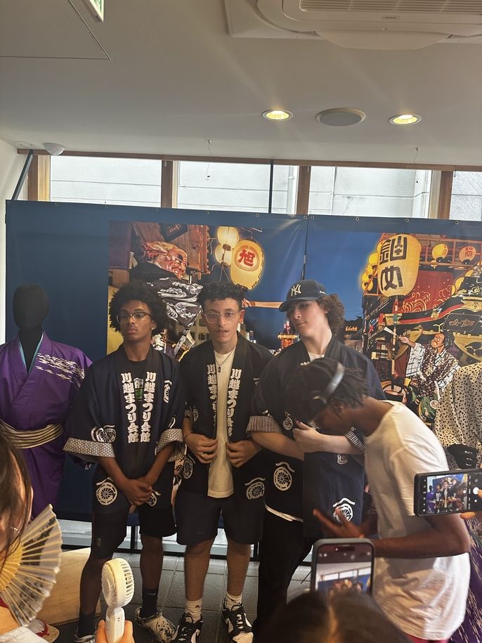 group 3 and 4 students at museum posting with festival happi jacket