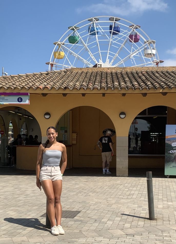 girl in front of farris wheel