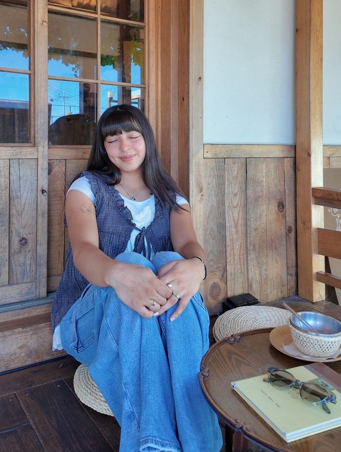 Author posing in front of cafe