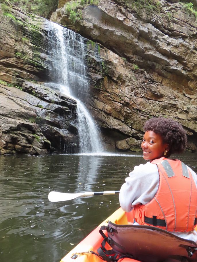 student abroad kayaking waterfall