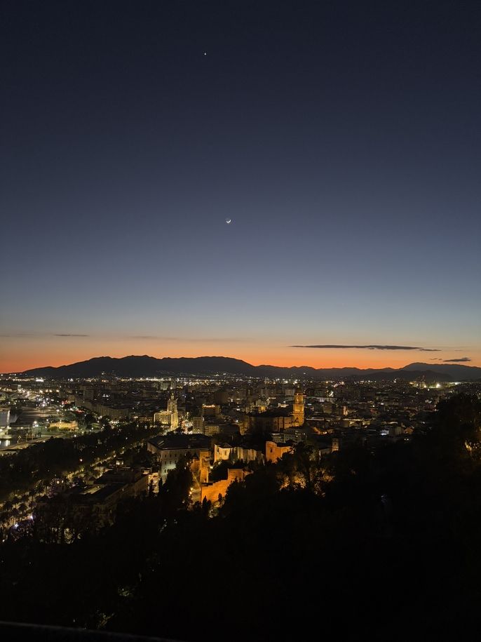 An aerial view of the city and harbor of Málaga, Spain at sunset
