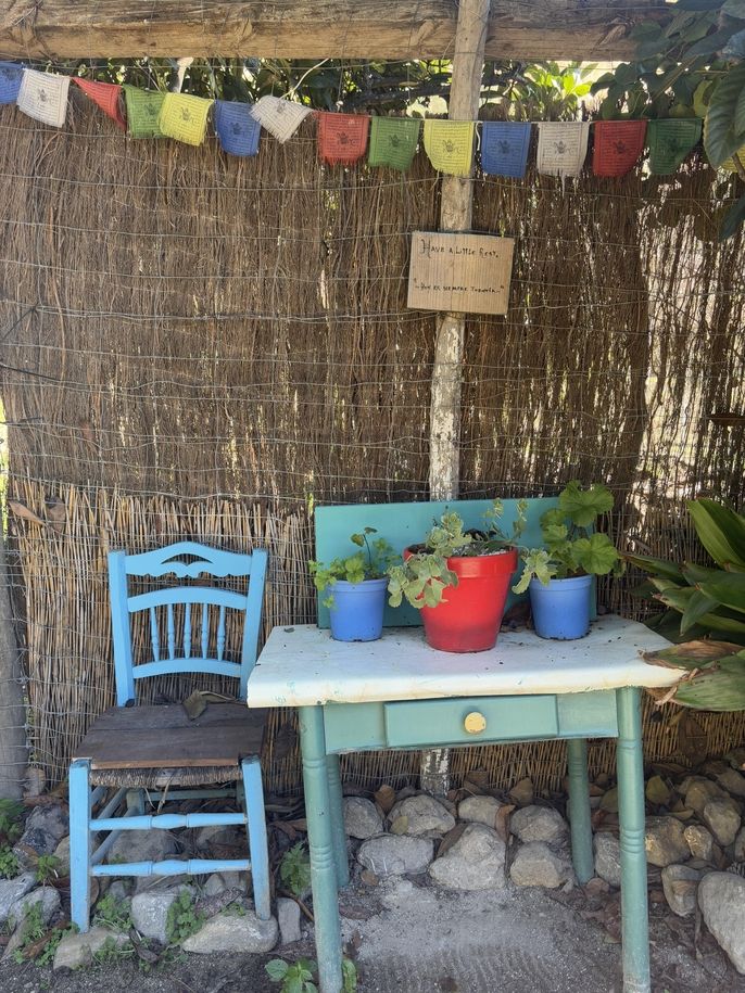 A rest spot with a sign that says "Have a little rest; Hoy es siempre todavia"