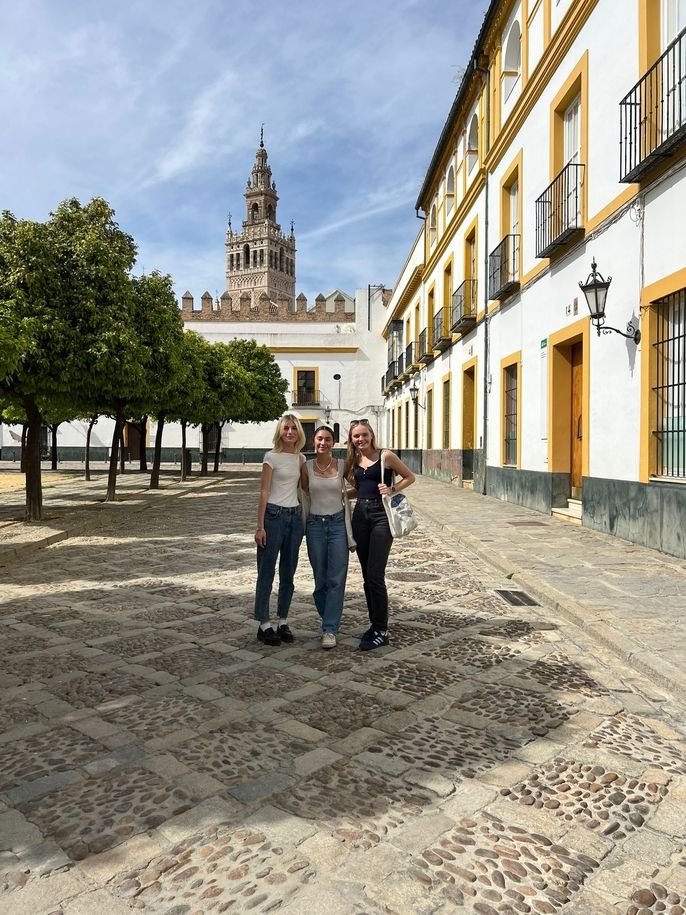 Trio of young girls posing in Seville while studying abroad