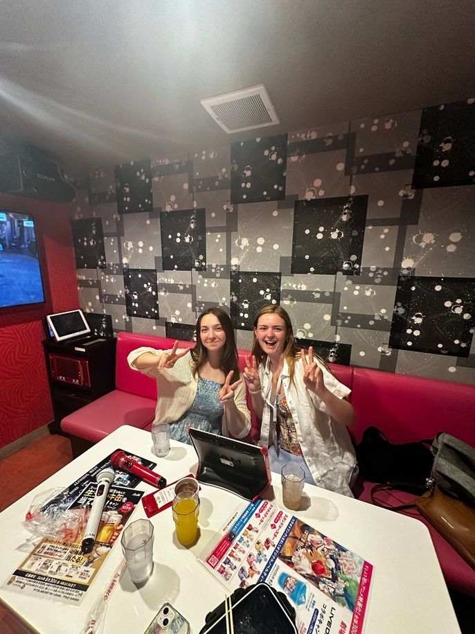 Two high school students posing in Japanese restaurant with bubbles